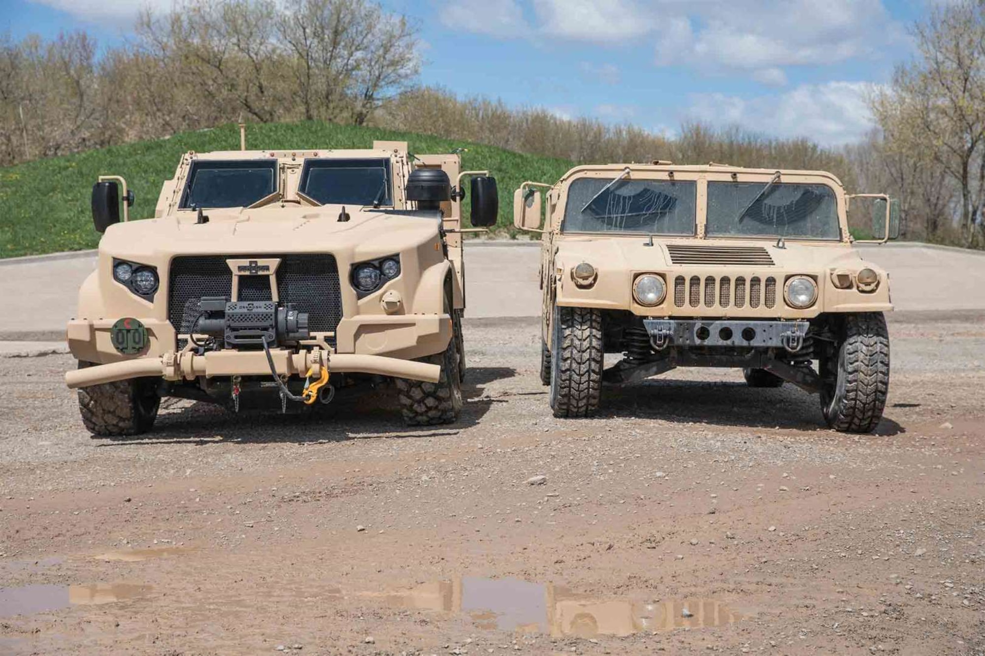 The Air Force Life Cycle Management Center's Agile Combat Support Directorate is working to replace the up-armored High Mobility Multipurpose Wheeled Vehicles, or Humvee (right), with the Joint Light Tactical Vehicles (left). (Courtesy Photo)