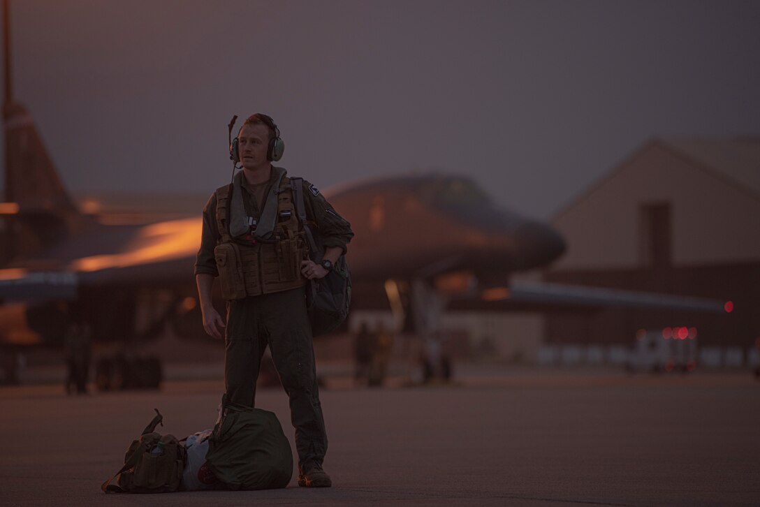 A 9th Expeditionary Bomb Squadron pilot waits to board a B-1B Lancer at Dyess Air Force Base, Texas, Oct. 19, 2020. The 9th EBS and Airmen assigned to the 7th Bomb Wing deployed in support of a Bomber Task Force operation. A BTF operation enhances the readiness and training required to rapidly respond to any contingency or challenge anywhere in the world. (U.S. Air Force photo by Airman 1st Class Colin Hollowell)