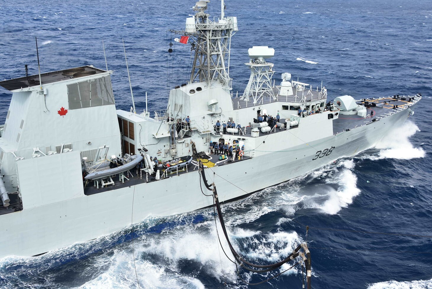 HMCS Winnipeg (FFH 338), a Halifax-class frigate in the Royal Canadian Navy fleet, receives a refueling probe from the U.S. Navy Military Sealift Command Henry J. Kaiser-class fleet replenishment oiler USNS Tippecanoe (T-AO 199) in preparation for an underway replenishment during Keen Sword.