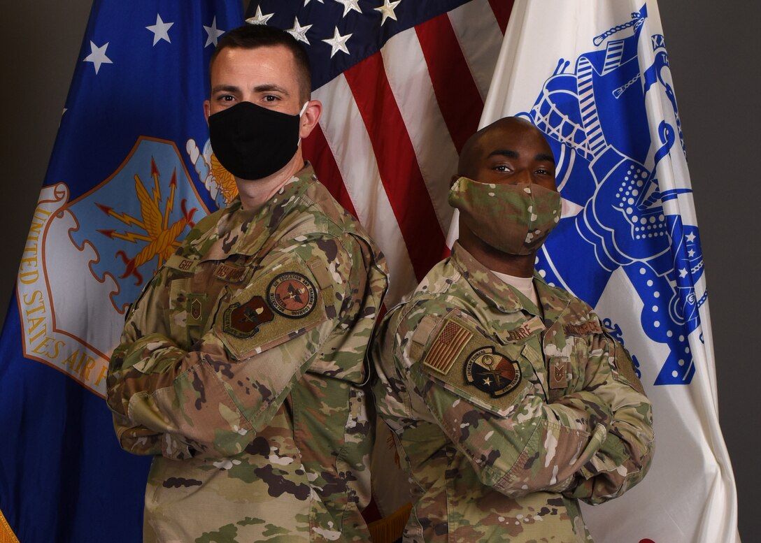 U.S. Air Force Master Sgt. Justin Geer, 316th Training Squadron cryptologic language analyst training flight chief, and Tech Sgt. Raphael Lazare, 316th TRS instructor supervisor, stand together for a photo, Goodfellow Air Force Base, Texas, Oct. 21, 2020. Geer was selected for Officer Training School and Lazare was selected to become an Army Warrant Officer. (U.S. Air Force photo by 1st Lt. Michael Crane)