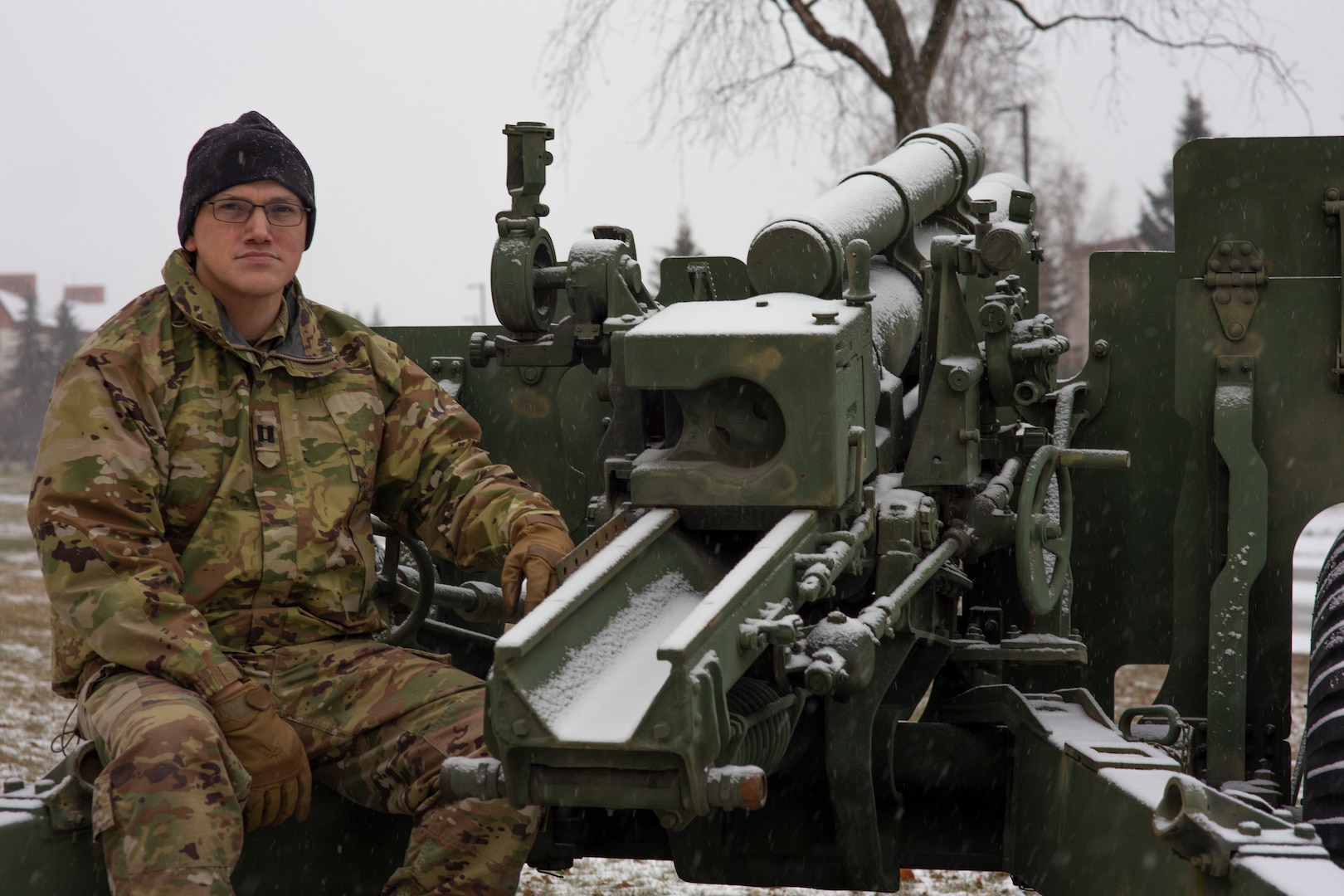 Capt. David Bedard, commander of the 134th Public Affairs Detachment, Alaska Army National Guard, on an M2A4 Howitzer cannon at Joint Base Elmendorf-Richardson, Alaska, Nov. 6, 2020. Bedard, a former artillery officer, is an Inupiaq Alaska Native. November is observed as Native American Indian and Alaska Native Heritage month.