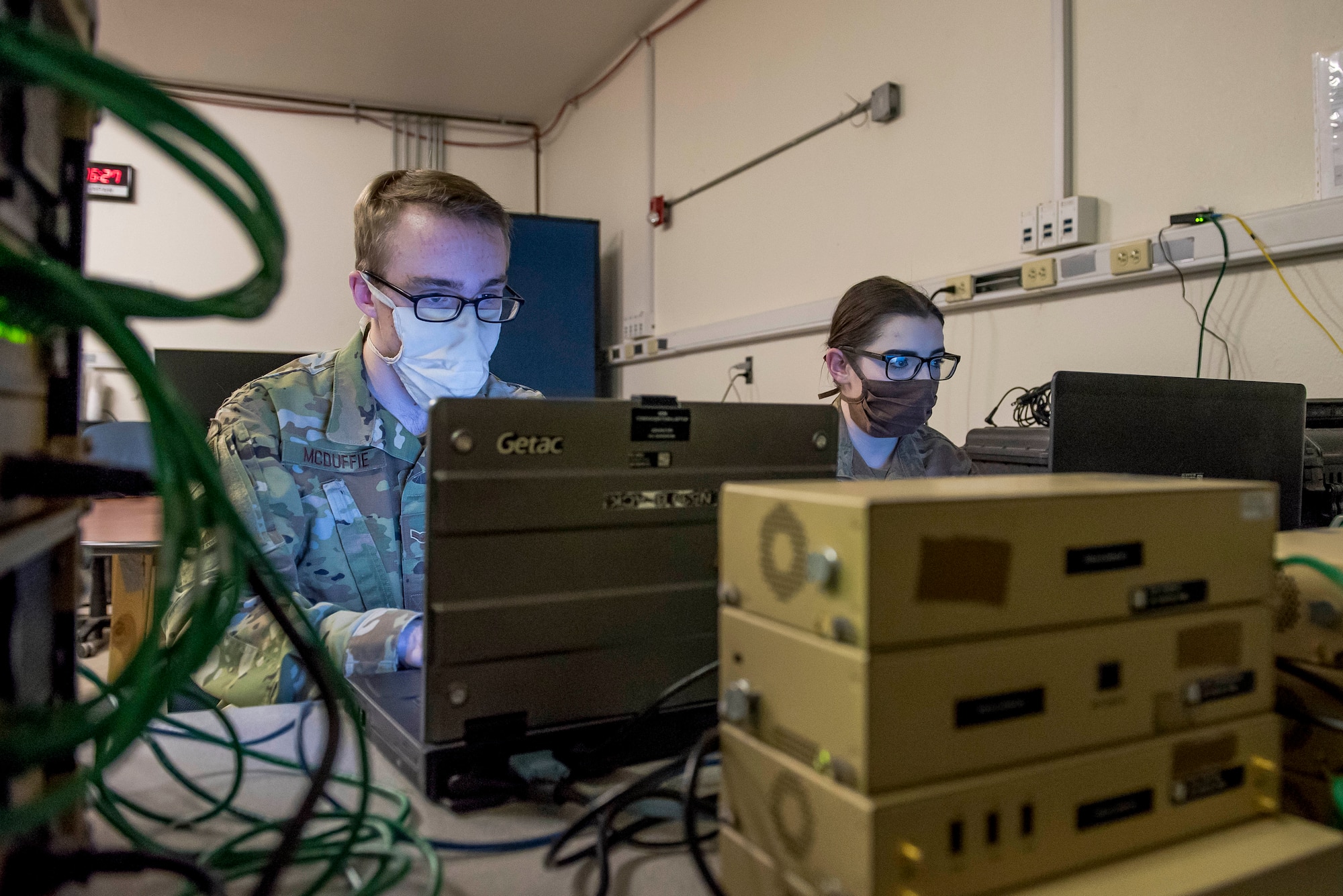 Airman 1st Class Logan McDuffie and Senior Airman Renee Beyrau, 27th Special Operations Communications Squadron tactical local access network team members, watch over the online system access provided to others during Operation Valex at Cannon Air Force Base, N.M., Nov. 3, 2020. The TACLAN system being used at Cannon is the only live model in Air Force Special Operations Command and United States Special Operations Command. (U.S. Air Force photo by Senior Airman Vernon R. Walter III)