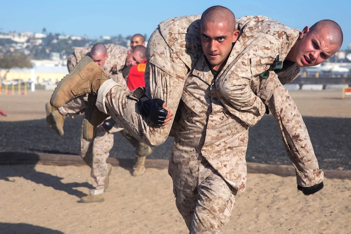 Rct. Nathaniel M. Cabico with Charlie Company, 1st Recruit Training Battalion, carries Rct. Alexander T. Sykora with Charlie Company, 1st Recruit Training Battalion, while participating in the Combat Conditioning Course at Marine Corps Recruit Depot, San Diego, Nov. 4, 2020