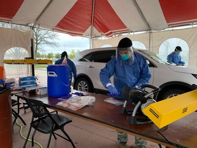 Citizen-Soldiers and Citizen-Airmen from the Wisconsin National Guard collect specimens for COVID-19 testing Oct. 26, 2020, at a community-based testing site at the Waukesha County Expo Center in Waukesha. The Wisconsin National Guard has collected more than 800,000 specimens across the state.