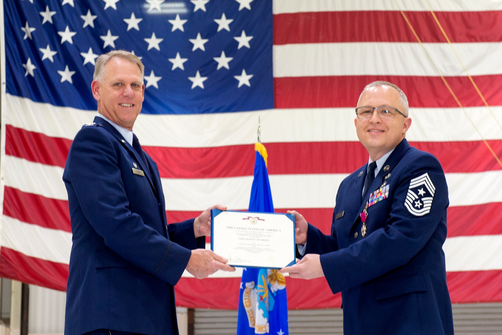 Col. Larry Shaw, 434th Air Refueling Wing commander, presents Chief Master Sgt. Wes Marion, 434th ARW command chief, with his certificate of retirement during his retirement ceremony at Grissom Air Reserve Base, Ind., Nov. 8, 2020. Marion became Grissom’s command chief in 2016. (U.S. Air Force photo/Master Sgt. Ben Mota)