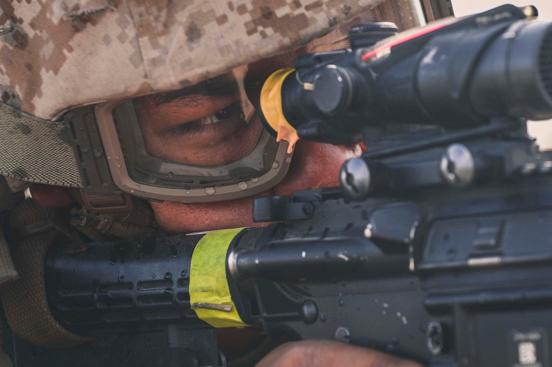 A Marine looks through the scope of a weapon.