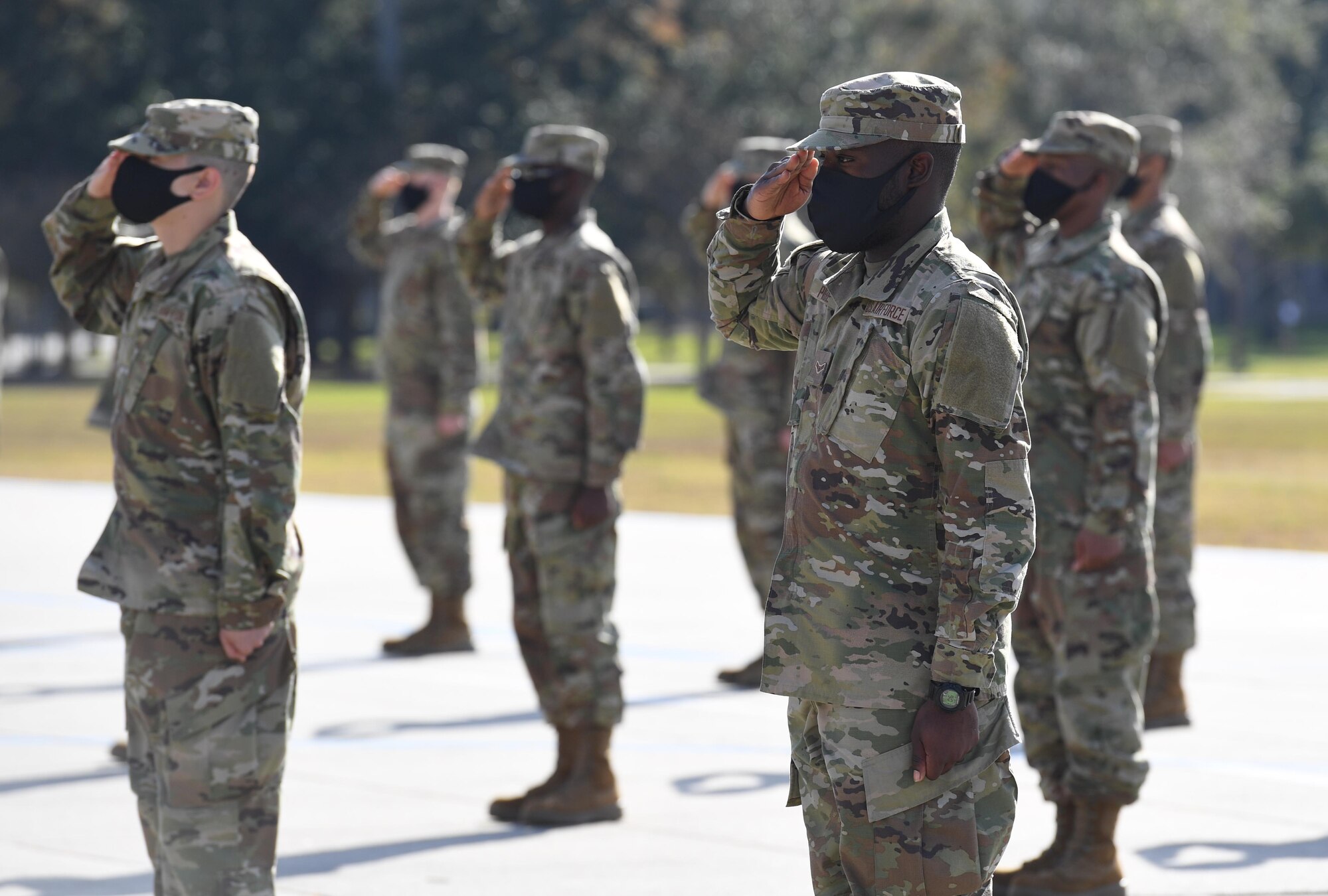Graduating basic military training trainees render a salute during the final BMT graduation ceremony on the Levitow Training Support Facility drill pad at Keesler Air Force Base, Mississippi, Nov. 6, 2020. Nearly 60 trainees from the 37th Training Wing Detachment 5 completed the six-week BMT course. Throughout the duration of BMT training at Keesler, 18 flights and 939 Airmen graduated. (U.S. Air Force photo by Kemberly Groue)