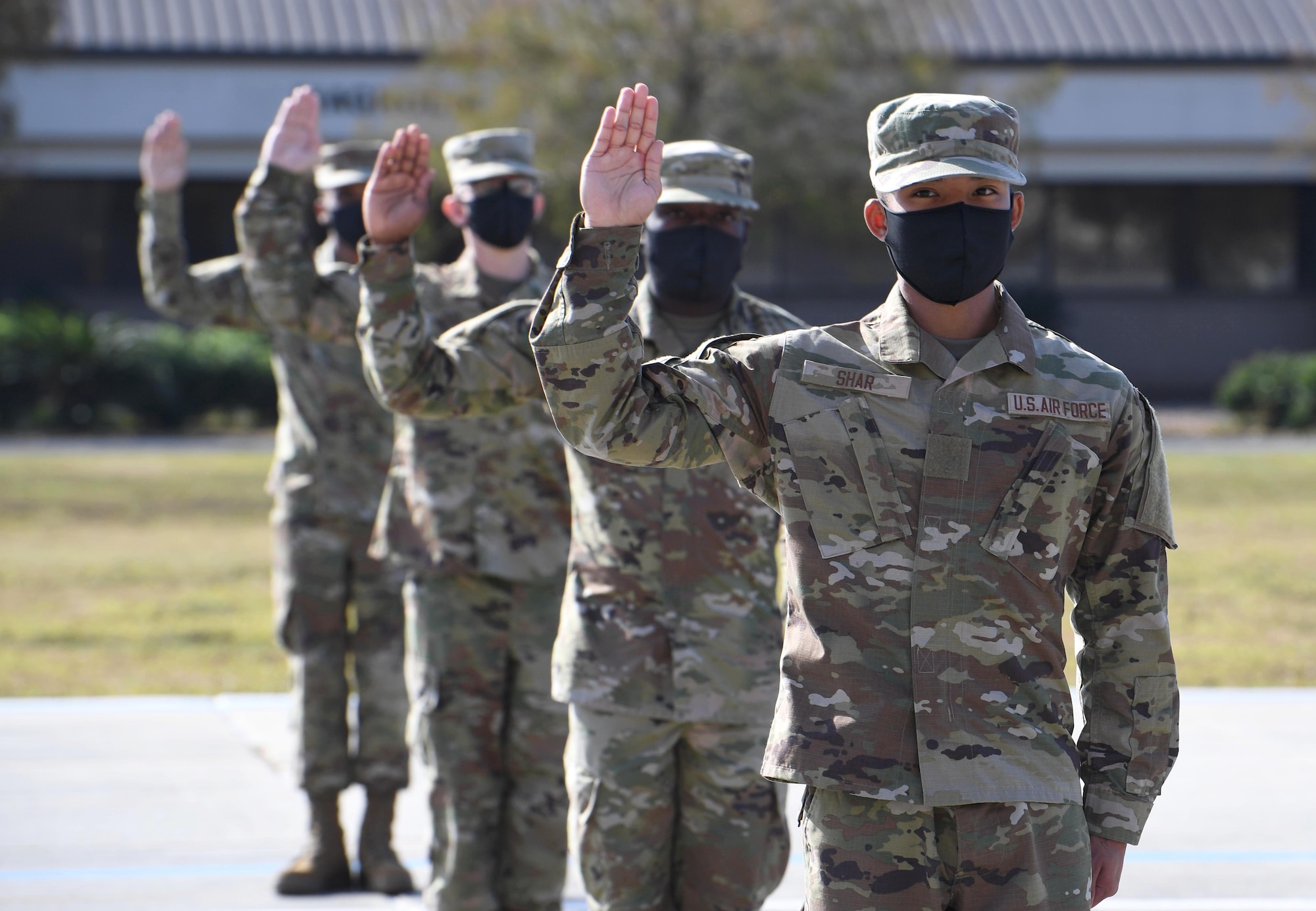 Graduating basic military training trainees recite the Oath of Enlistment during the final BMT graduation ceremony on the Levitow Training Support Facility drill pad at Keesler Air Force Base, Mississippi, Nov. 6, 2020. Nearly 60 trainees from the 37th Training Wing Detachment 5 completed the six-week BMT course. Throughout the duration of BMT training at Keesler, 18 flights and 939 Airmen graduated. (U.S. Air Force photo by Kemberly Groue)