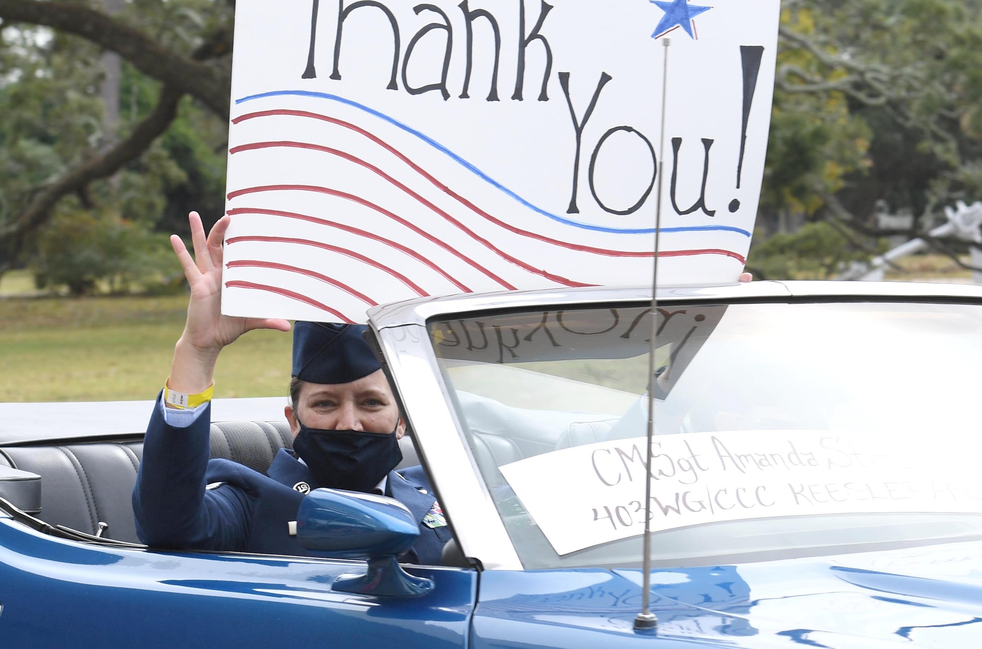 U.S. Air Force Chief Master Sgt. Amanda Stift, 403rd Wing command chief, holds a thank you sign during the Gulf Coast Veteran's Day Roll-Thru and Wave Parade outside the Armed Forces Retirement Home at Gulfport, Mississippi, Nov. 7, 2020. Keesler Air Force Base leadership participated in the parade in support of all veterans past and present. (U.S. Air Force photo by Kemberly Groue)