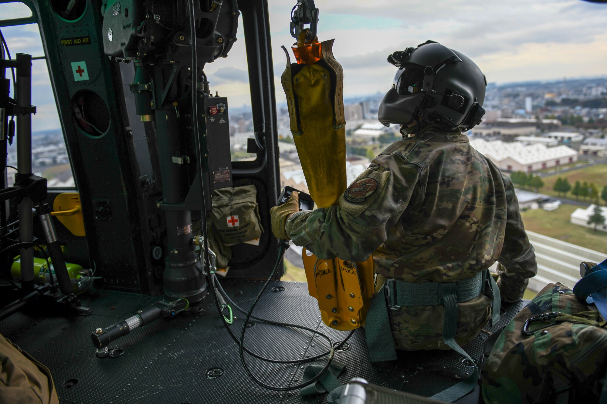 Flight engineer assesses an internal rescue hoist.