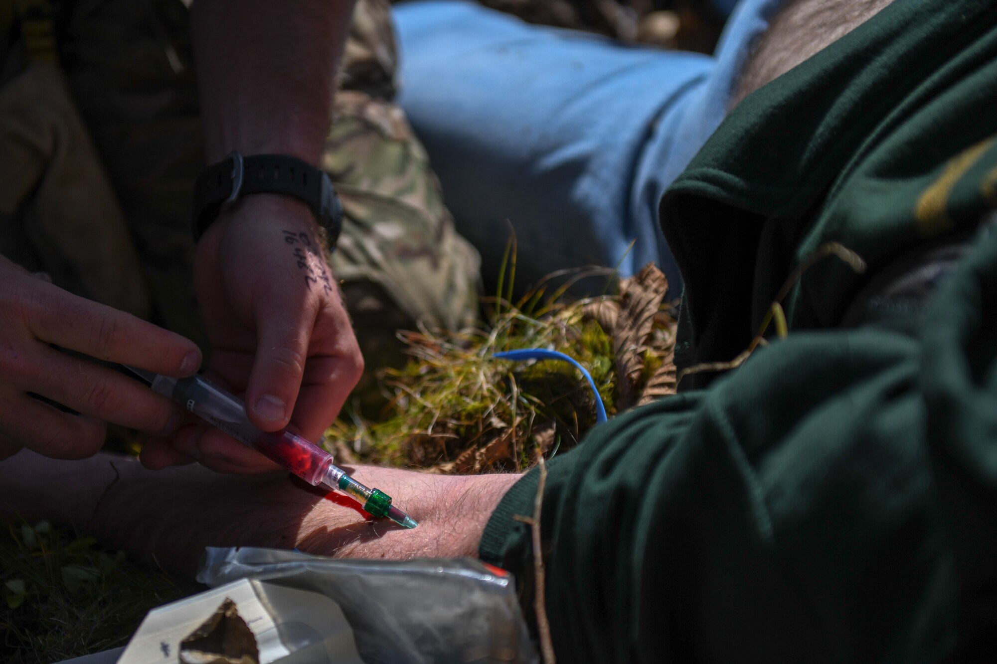 Operator draws blood from a simulated victim.