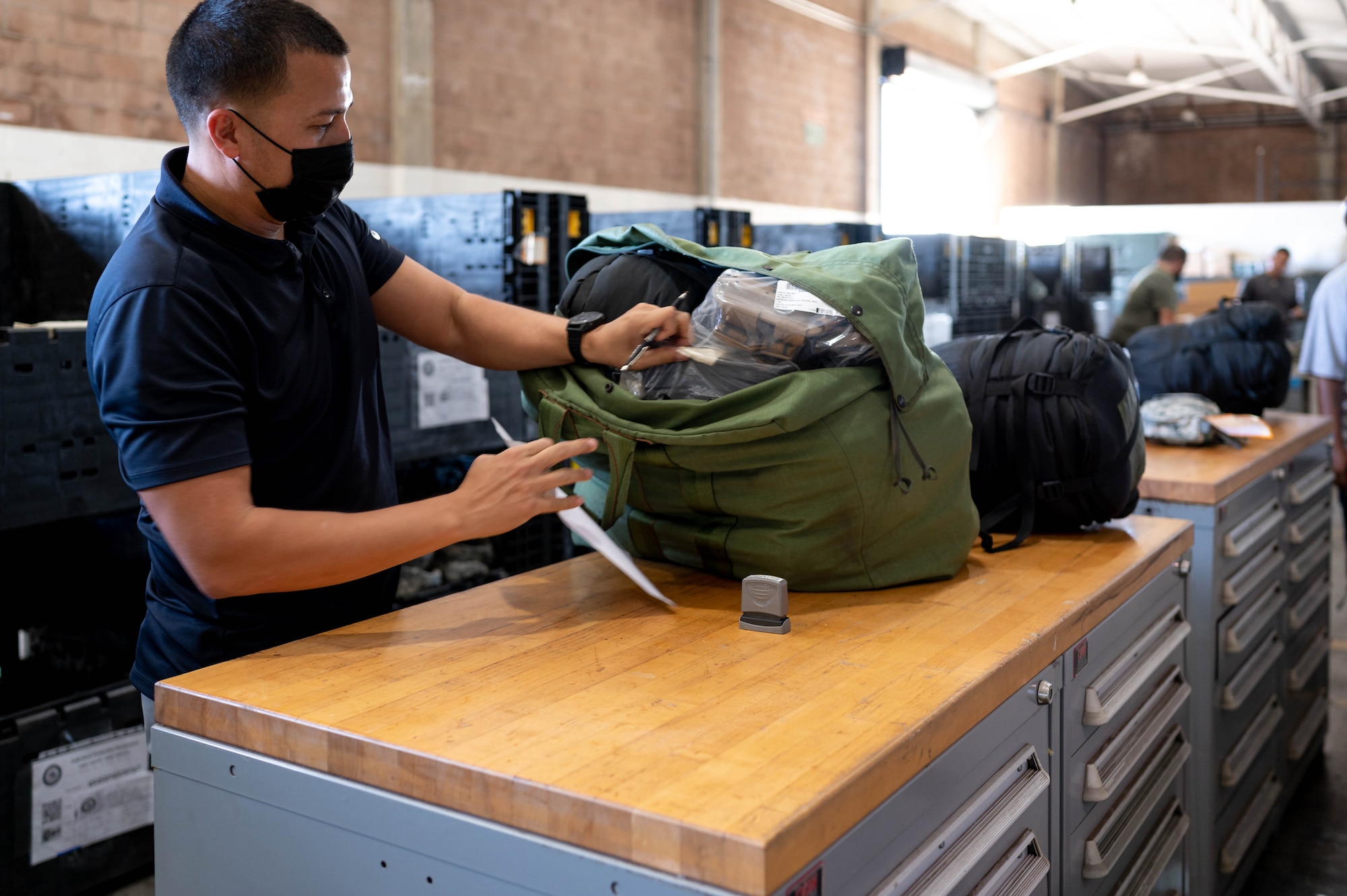 201105-N-TA290-1001 HONOLULU (November 5, 2020) Naval Supply Systems Command Fleet Logistics Center Pearl Harbor, material handler, Marcan Aldan performs quality assurance checks on the A-bag (combat load) in support of the 647th Logistics Readiness Squadron participation in the 15th Wing's annual Tropic Tempest exercise. (U.S. Navy photo by Daniel Mayberry/Released)