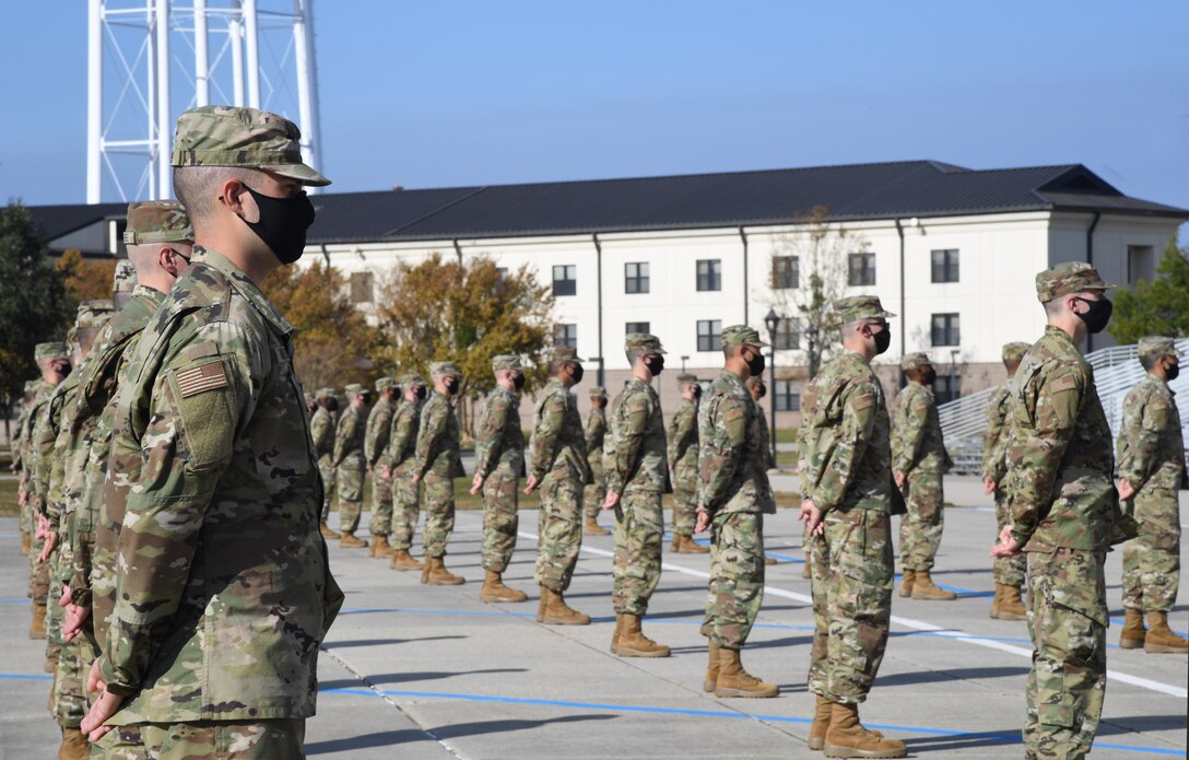 Graduating basic military training trainees stand in formation on the Levitow Training Support Facility drill pad during the final BMT graduation ceremony at Keesler Air Force Base, Mississippi, Nov. 6, 2020. Nearly 60 trainees from the 37th Training Wing Detachment 5 completed the six-week BMT course. Throughout the duration of BMT training at Keesler, 18 flights and 939 Airmen graduated. (U.S. Air Force photo by Kemberly Groue)