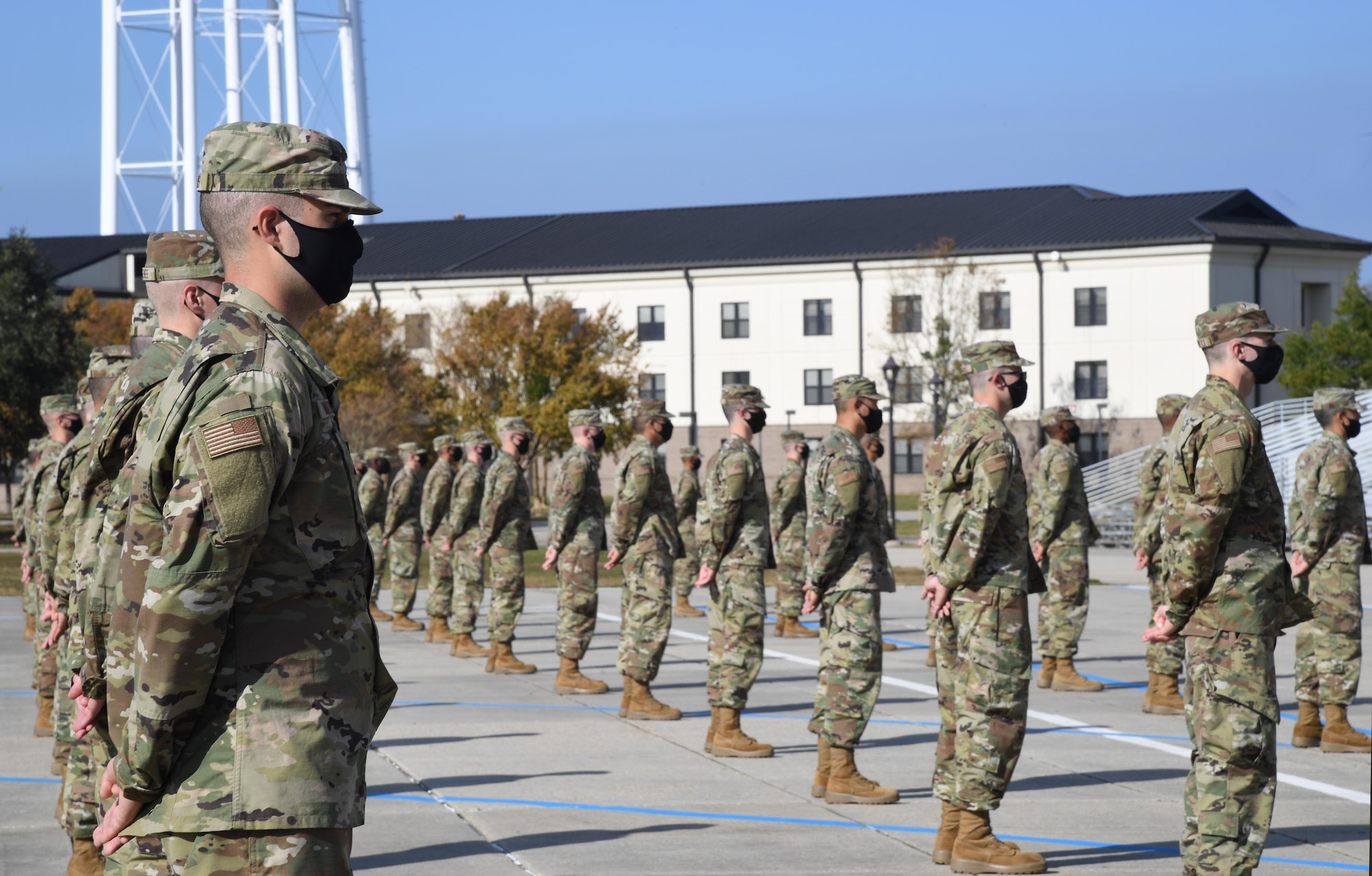 Graduating basic military training trainees stand in formation on the Levitow Training Support Facility drill pad during the final BMT graduation ceremony at Keesler Air Force Base, Mississippi, Nov. 6, 2020. Nearly 60 trainees from the 37th Training Wing Detachment 5 completed the six-week BMT course. Throughout the duration of BMT training at Keesler, 18 flights and 939 Airmen graduated. (U.S. Air Force photo by Kemberly Groue)