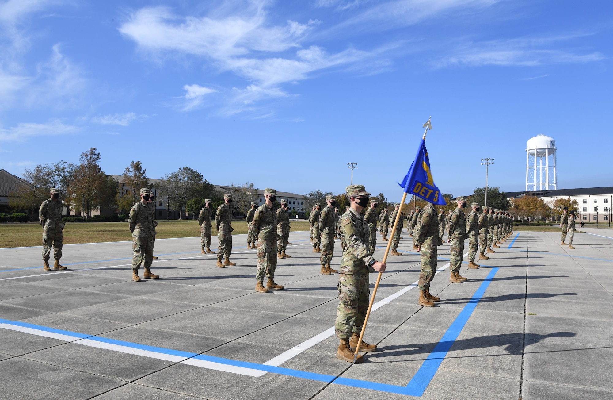 Graduating basic military training trainees stand in formation on the Levitow Training Support Facility drill pad during the final BMT graduation ceremony at Keesler Air Force Base, Mississippi, Nov. 6, 2020. Nearly 60 trainees from the 37th Training Wing Detachment 5 completed the six-week BMT course. Throughout the duration of BMT training at Keesler, 18 flights and 939 Airmen graduated. (U.S. Air Force photo by Kemberly Groue)