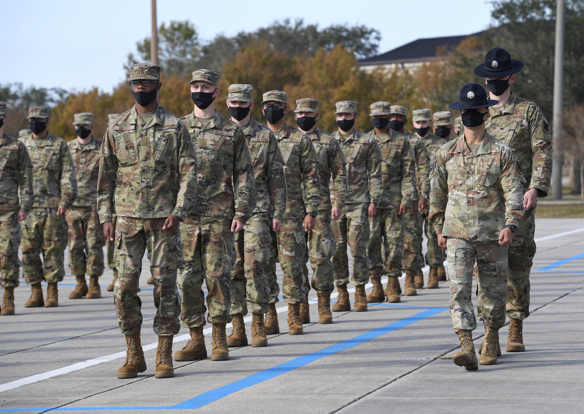 Military training instructors lead graduating basic military training trainees off the Levitow Training Support Facility drill pad during the final BMT graduation ceremony at Keesler Air Force Base, Mississippi, Nov. 6, 2020. Nearly 60 trainees from the 37th Training Wing Detachment 5 completed the six-week BMT course. Throughout the duration of BMT training at Keesler, 18 flights and 939 Airmen graduated. (U.S. Air Force photo by Kemberly Groue)