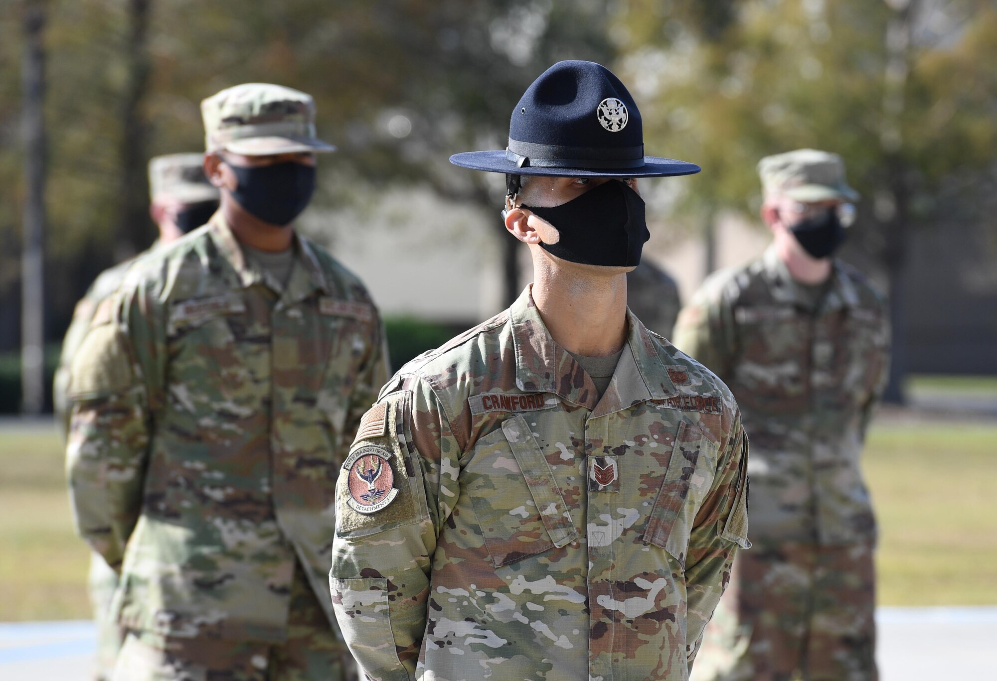 U.S. Air Force Tech. Sgt. Tyler Crawford, 37th Training Wing Detachment 5 military training instructor, and graduating basic military training trainees stand in formation on the Levitow Training Support Facility drill pad during the final BMT graduation ceremony at Keesler Air Force Base, Mississippi, Nov. 6, 2020. Nearly 60 trainees from the 37th TRW Detachment 5 completed the six-week BMT course. Throughout the duration of BMT training at Keesler, 18 flights and 939 Airmen graduated. (U.S. Air Force photo by Kemberly Groue)