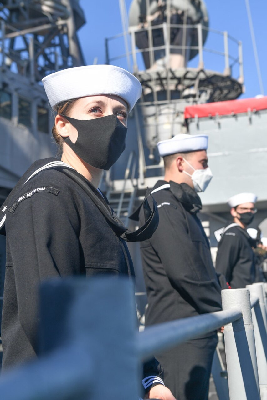 YOKOSUKA, Japan (Nov. 10, 2020) - Cryptologic Technician (Technical) 1st Class Brittany Britos, from Fort Collins, Colo., mans the rails as the Ticonderoga-class guided-missile cruiser USS Antietam (CG 54) returns to port, Yokosuka, Japan. Antietam’s return marked the end of a nine-month deployment in the U.S. 7th Fleet area of responsibility in support of security and stability in the Indo-Pacific.