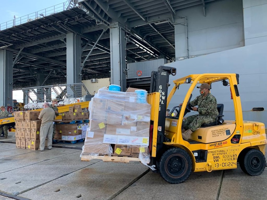 Logistics Support Petty Officer 2nd Class Ramiro Mendoza, Naval Supply Systems Command, drives a HYSTER 6K forklift to transfer supplies and provisions to USS Hershel “Woody” Williams (ESB 4) during a port visit Oct. 22, 2020 at Naval Station Rota, Spain. The Expeditionary Staging Base ship conducts Africa Command missions in the Mediterranean and the waters around East, South, and West Africa to include the Gulf of Guinea, operating with regional Allies and partners.