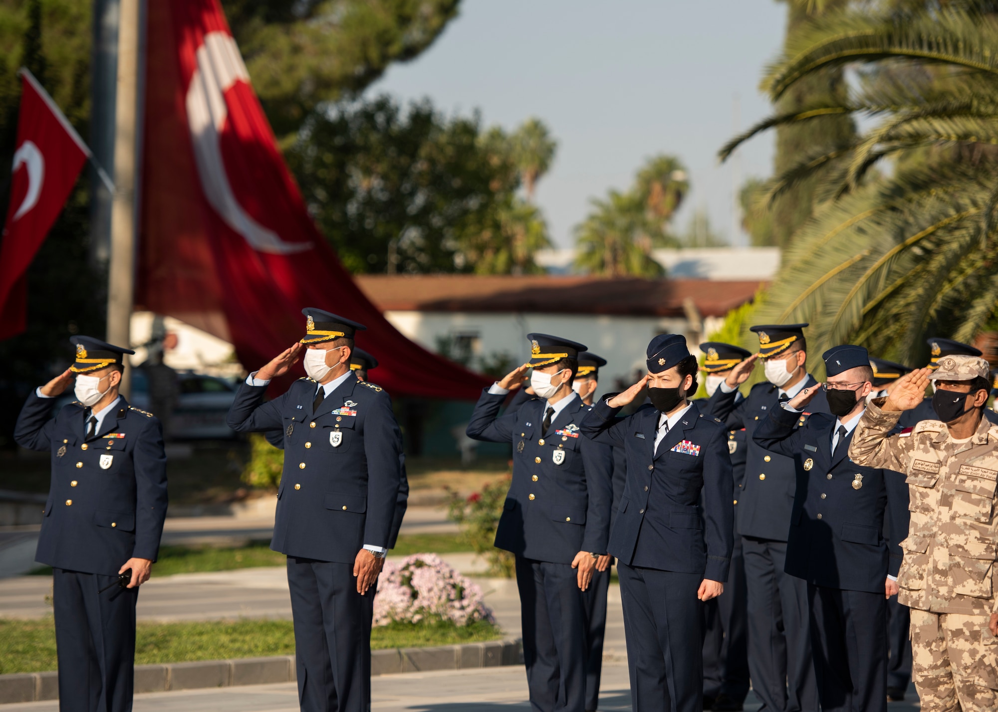 U.S. Air Force and Turkish Air Force personnel render a salute during a ceremony.