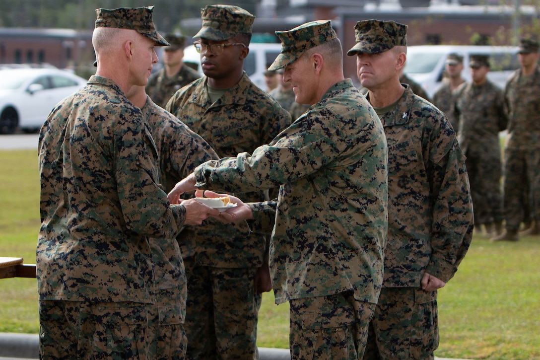 Maj. Gen. James F. Glynn passes a piece of the cake to the guest of honor, Lt. Gen. George W. Smith during the 245th Marine Corps Birthday cake cutting ceremony at Camp Lejeune, North Carolina, Nov. 6.