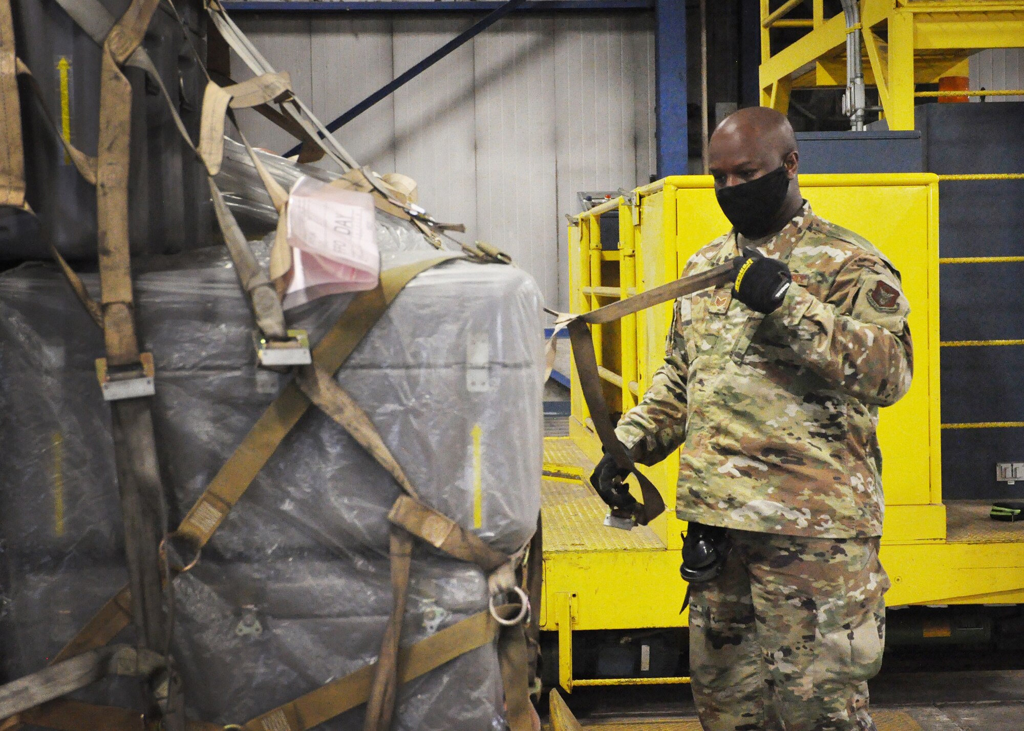 Staff Sgt. Dylan Lewis-Lee, 87th Aerial Port Squadron ramp operations specialist, tightens the net on a training pallet during the 87th Aerial Port Squadron’s semi-annual Port Dawg Challenge Oct. 17, 2020. Cargo is prepared for military airlift using strict guidelines based on weight, height, shape and transportation priority, so Port Dawgs must be proficient in numerous methods of securing cargo with nets, chains and straps.