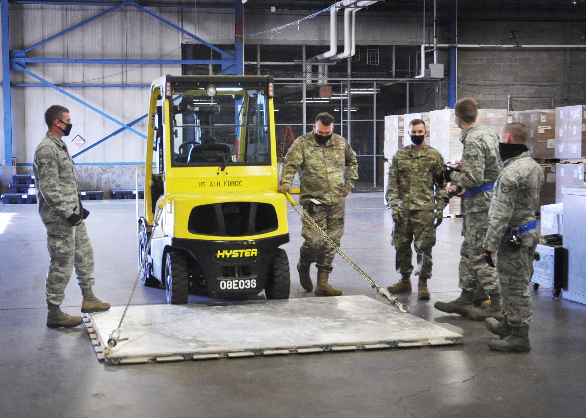 Airmen of the 87th Aerial Port Squadron use chains to restrain a 463L pallet (a standardized pallet used for transporting military air cargo). This challenge simulated tying down a vehicle on a C-17 Globemaster III and calculated the effectiveness angle of the chains. A forklift was backed up to the edge of the pallet, and the group was given two different angles and lengths to figure out the effective restraint that each chain would provide.