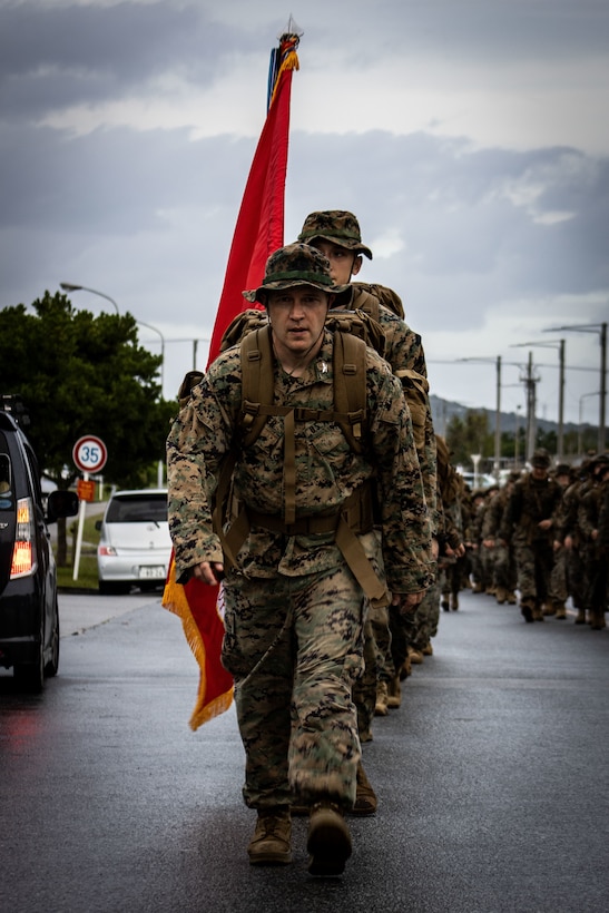 U.S. Marines Corps Col. Lester Gerber leads Marines on a five kilometer hike on Camp Hansen, Okinawa, Japan, Nov. 9.