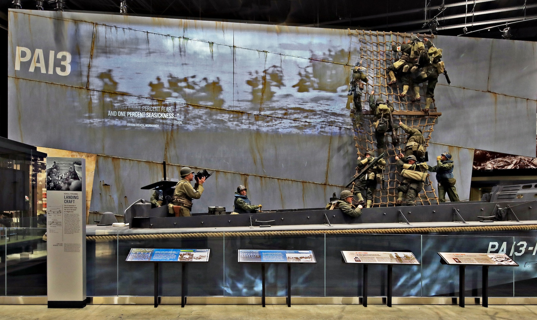 Three New York Army National Guard Soldiers posed for figures in this exhibit at the National Museum of the United States Army of a Higgins boat landing in Normandy on D-Day, June 6, 1944. Maj. Kevin Vilardo was the model for the photographer in the stern, while 1st Lt. Sam Gerdt modeled the Soldier waiting at the side of the boat. Sgt. 1st Class Nick Archibald was the model for one of the Soldiers climbing down the cargo net. The museum opens to the public Nov. 11, 2020.