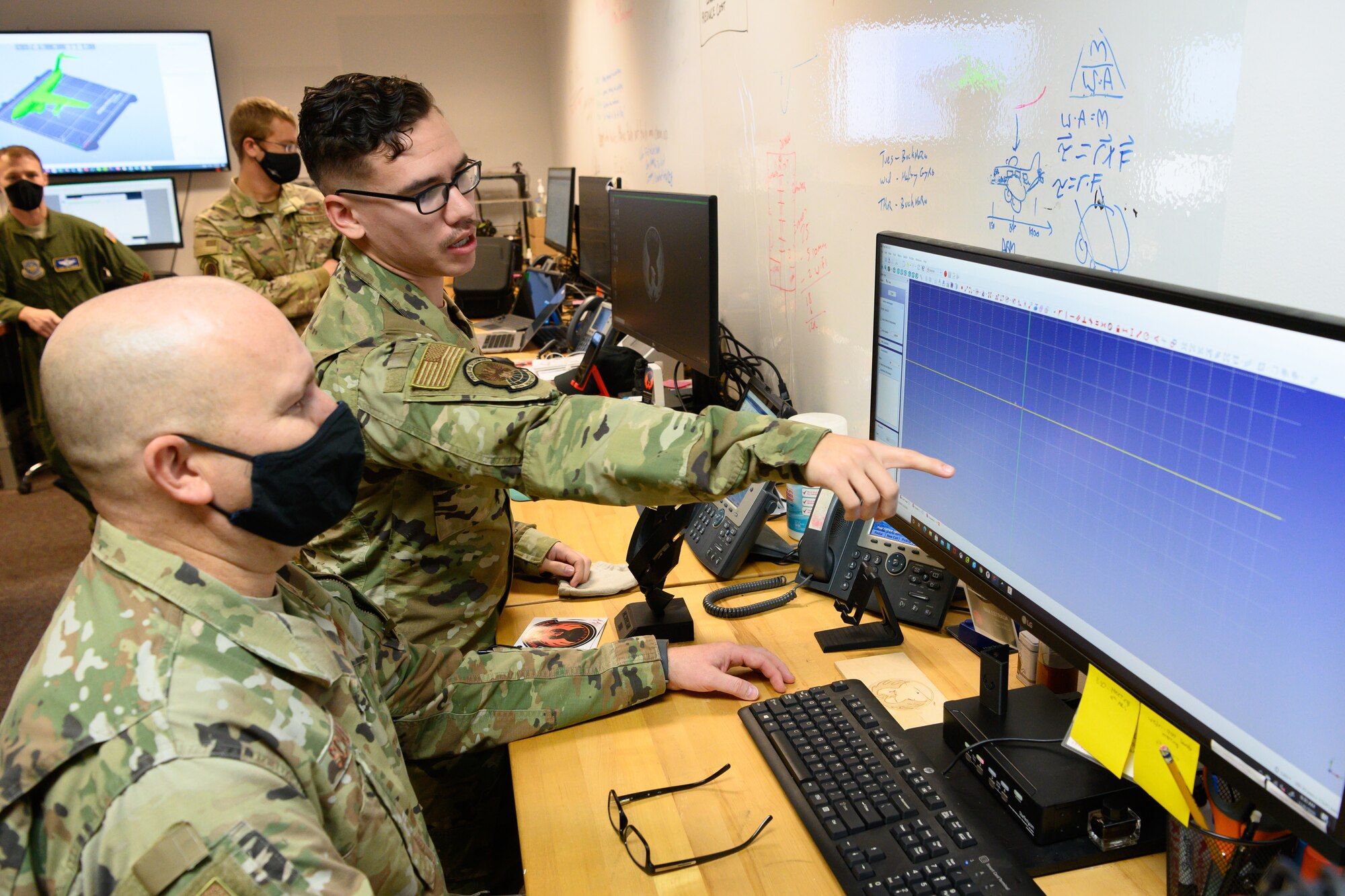 Airman shows software to chief.