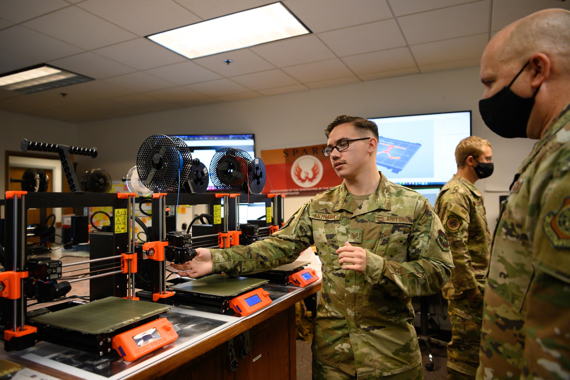 Airman shows 3D printers to chief