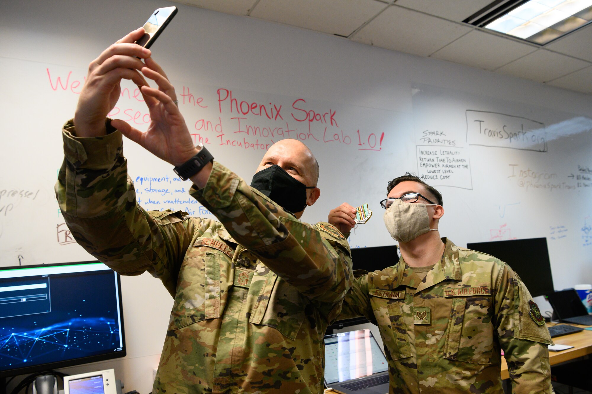 Chief taking selfie with Airman