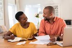 Cheerful smiling couple working on their healthcare planning.