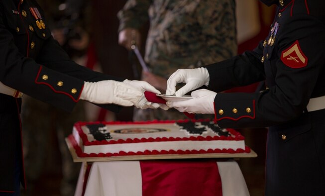 U.S. Marines with Marine Corps Installations Pacific, pass cake in celebration of the 245th Marine Corps Birthday ceremony at the Butler Officer’s Club, Plaza Housing, Okinawa, Japan, Nov. 3, 2020. The Marine Corps Birthday is celebrated by Marines all around the world every year on Nov. 10. The most notable ceremonial event is the cake-cutting ceremony which signifies the passing of time-honored traditions from the older generation to the younger generation. (U.S. Marine Corps Photo by Lance Cpl. Alex Fairchild)