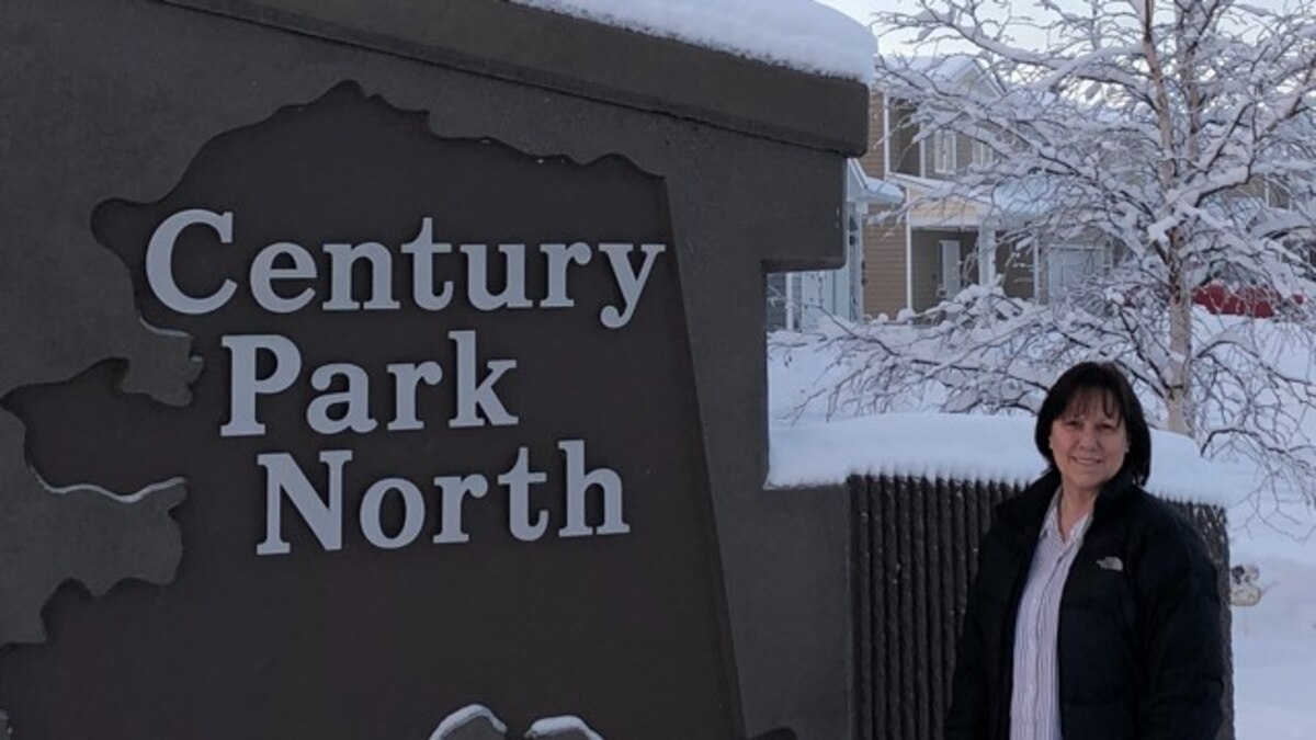 Ms. Diana Keener, 354th Fighter Wing resident advocate, stands in front of the entrance to Century Park North neighborhood of privatized housing on Eielson Air Force Base, Alaska, Nov 2, 2020.