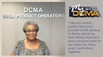 Smiling lady wearing a green and white shirt stands in front of a wall with the DCMA NASA Product Operations sign in the background