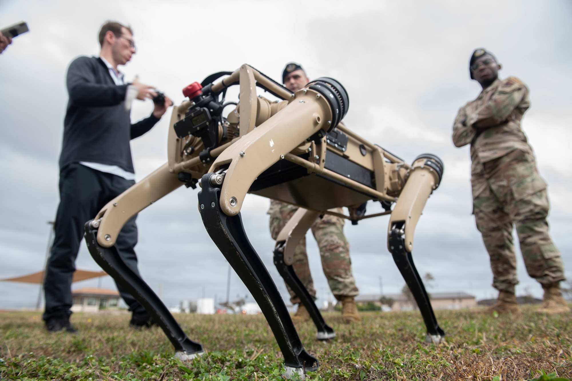 unmanned ground vehicle, men standing in background
