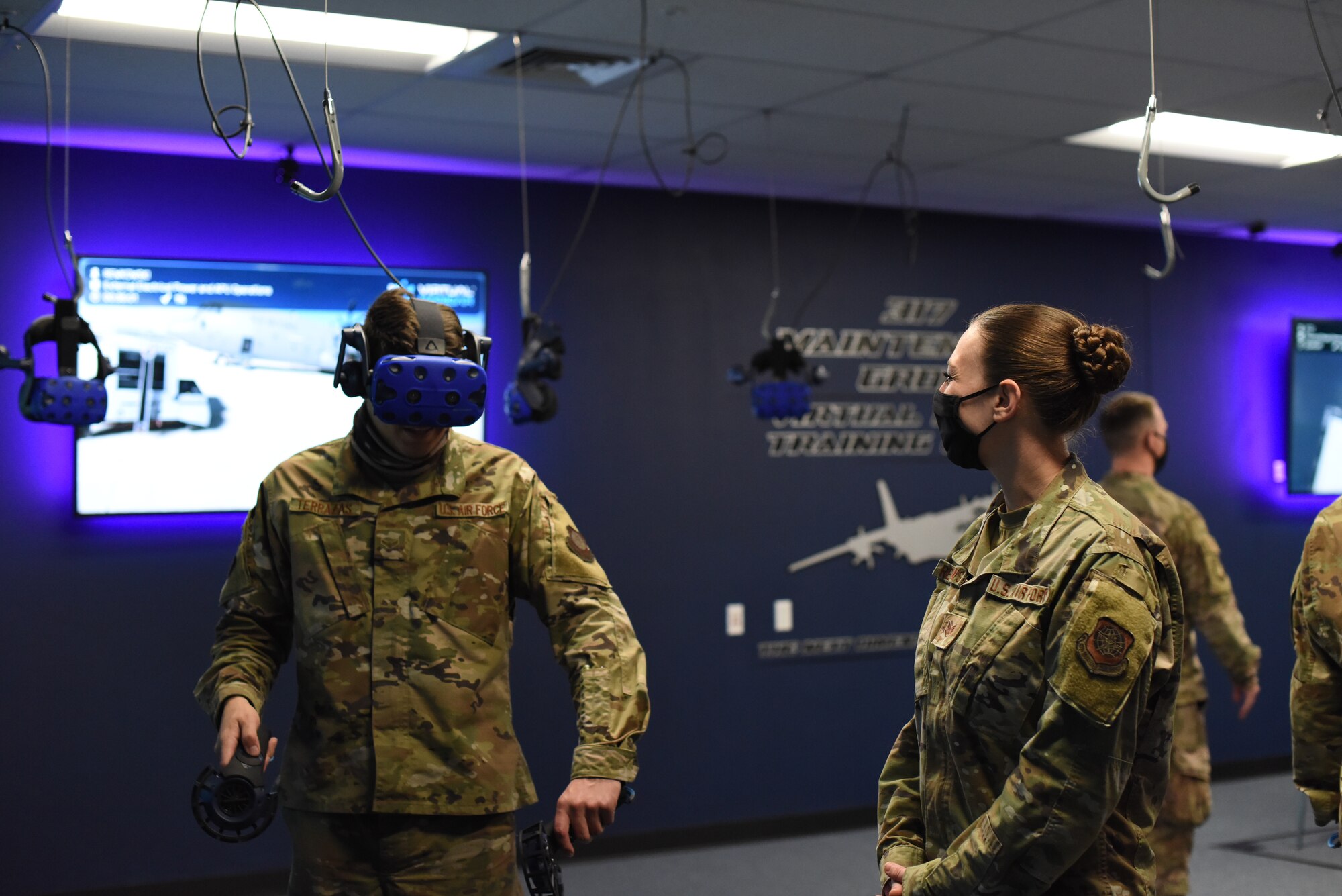 C-130 instructor provides feedback to Airmen during virtual reality training