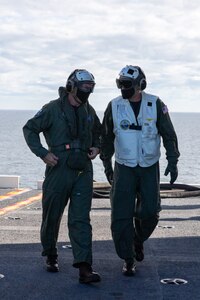 Rear Adm. Craig Claperton, commander, Carrier Strike Group (CSG) 12, left, walks with Capt. Jeremy Shamblee, USS Gerald R. Ford's executive officer, on the flight deck.