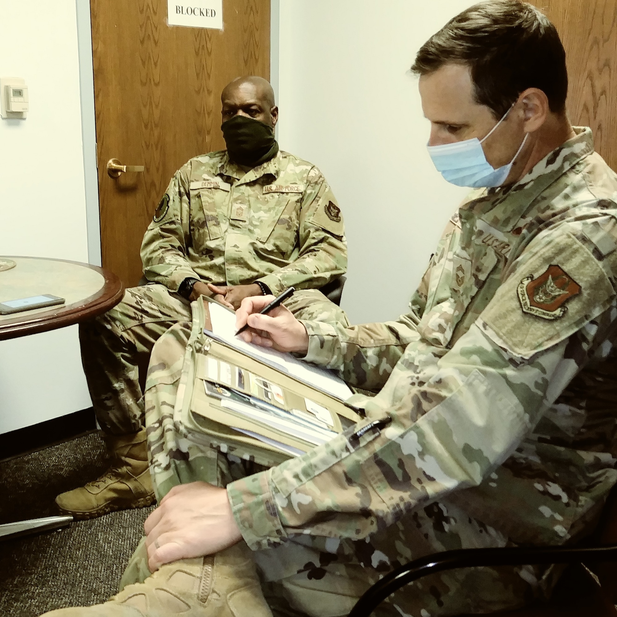 Chief  Master Sgt. Winston Demmin, 940th Maintenance Squadron superintendent practices social distancing, the  wearing of face coverings and limiting the number of persons per room during the Zoom conference.