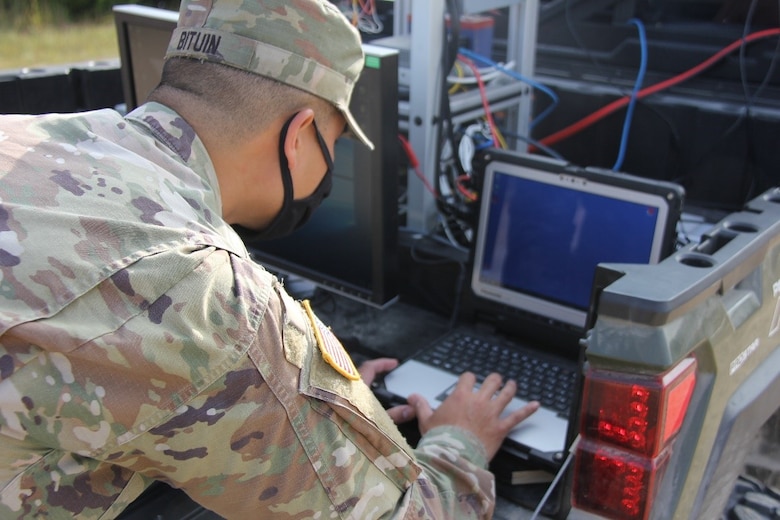 A Soldier stationed on Fort Leonard Wood, Mo., commands the computer system for the Mobility System for Crossing Off-Road and Urban Terrain (M-SCOUT) unmanned aerial vehicle (UAV) and prepares the unmanned aerial vehicle for system launch during the Maneuver Support, Sustainment and Protection Integration Experiments-2020, or MSSPIX-20, in Fort Leonard Wood, Sept. 16, 2020. The U.S. Army Engineer Research and Development Center researchers worked with Soldiers to test M-SCOUT during MSSPIX-20. M-SCOUT is a prototype warning system mounted inside a ground vehicle that displays mobility obstacles on a map, detected from a sensor data cloud on-board an unmanned aerial system. The live terrain data is combined with mobility performance models to updated routes and provide situational awareness to convoy commanders.