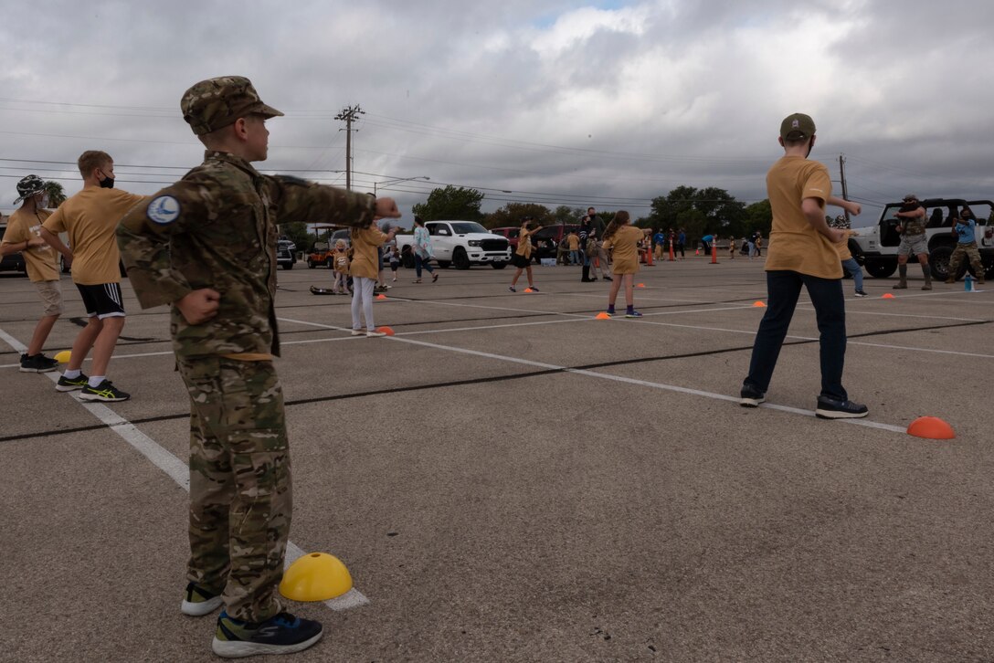 Junior deployers throw punches during a bootcamp-style workout on Nov. 7, 2020 at Laughlin Air Force Base, Texas. For many, the workout was exhilarating, and they got to experience the importance of physical training and see why it’s important for military members to remain fit. (U.S. Air Force photo by Senior Airman Anne McCready)