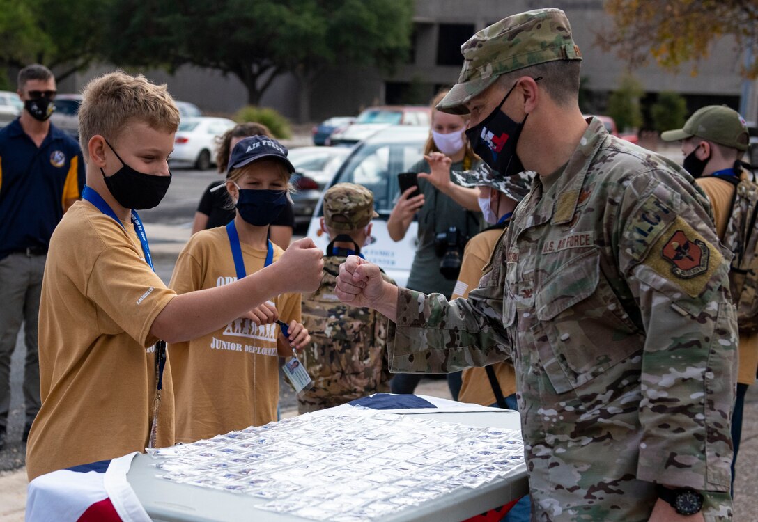 Col. Craig D. Prather, 47th Flying Training Wing commander, congratulates children as they finish their junior deployment here at Laughlin Air Force Base, Texas, Nov. 7, 2020. Junior Deployment provided children of military members an opportunity to have a glimpse at what their family members do during deployments. (Air Force photo by Airman 1st Class David Phaff)