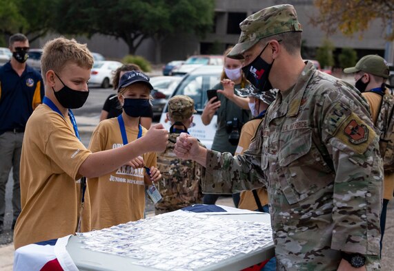 Col. Craig D. Prather, 47th Flying Training Wing commander, congratulates children as they finish their junior deployment here at Laughlin Air Force Base, Texas, Nov. 7, 2020. Junior Deployment provided children of military members an opportunity to have a glimpse at what their family members do during deployments. (Air Force photo by Airman 1st Class David Phaff)