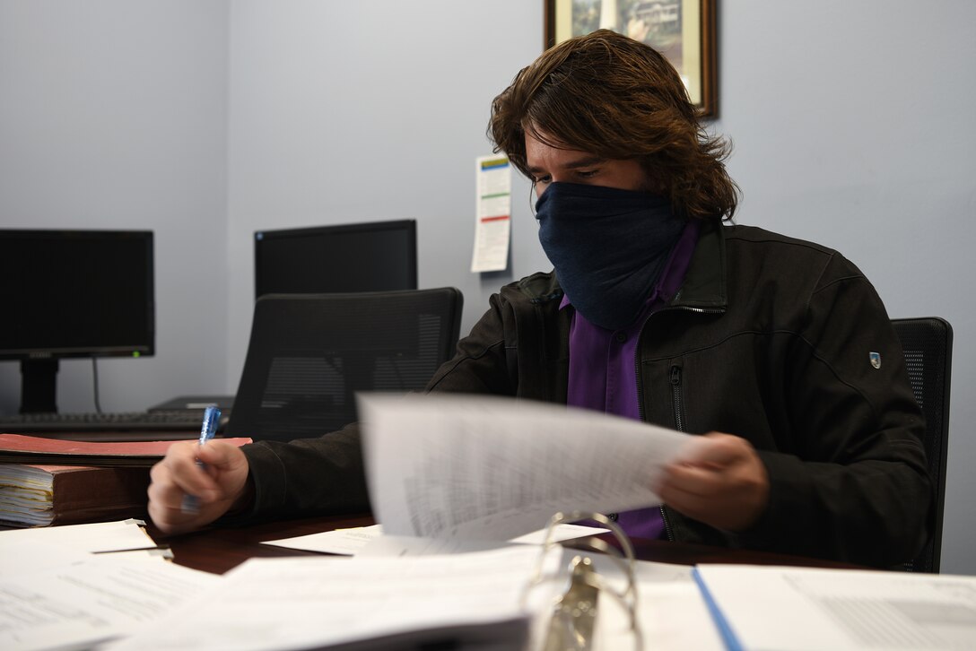 Logan Deluke, 81st Contracting Squadron contracting specialist, reviews a contract inside the 81st CONS building at Keesler Air Force Base, Mississippi, Nov. 5, 2020. The contracting squadron stepped up during the start of COVID-19 to meet the demands for the safety of the base and the continuation of the training pipeline. (U.S. Air Force photo by Senior Airman Suzie Plotnikov)