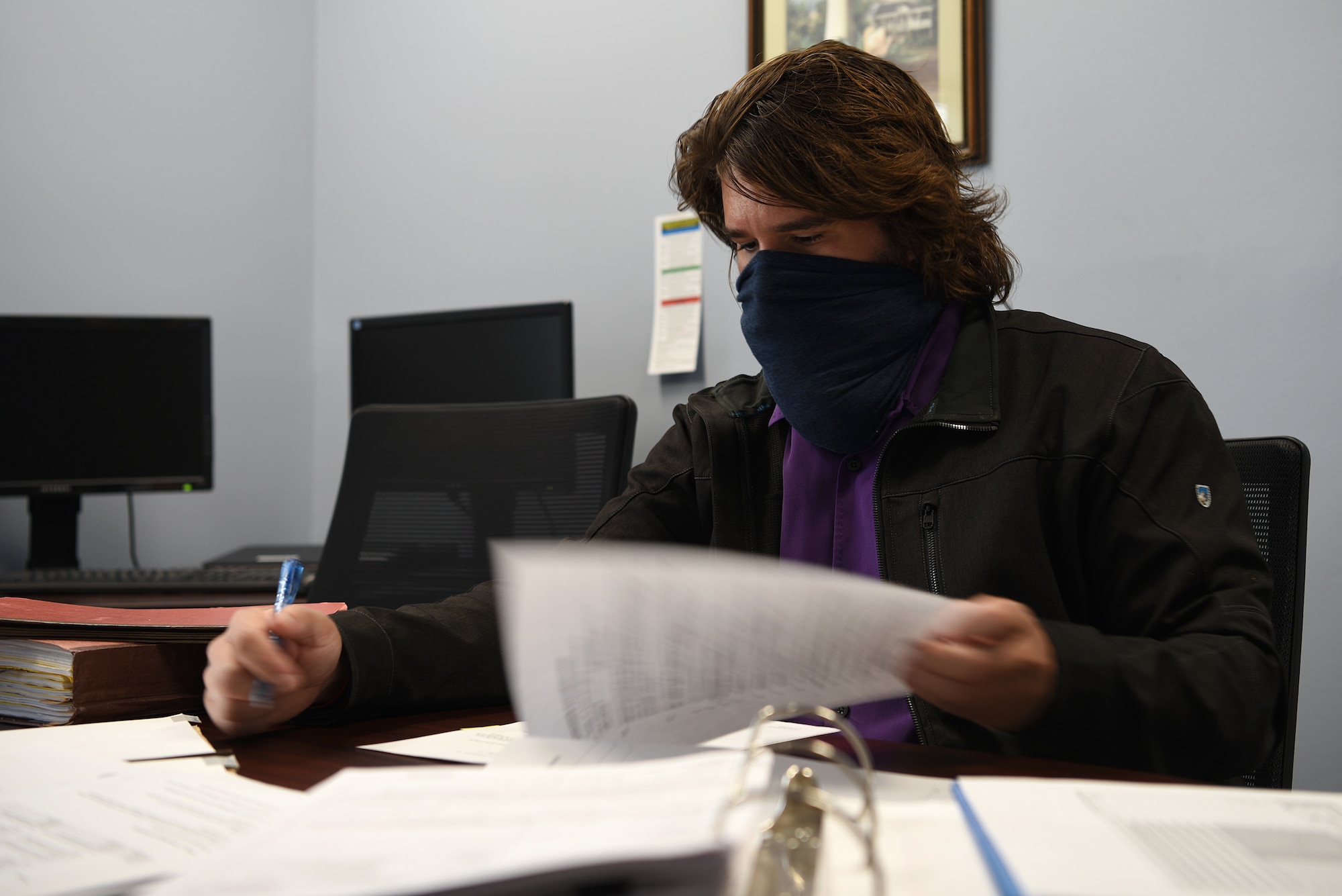 Logan Deluke, 81st Contracting Squadron contracting specialist, reviews a contract inside the 81st CONS building at Keesler Air Force Base, Mississippi, Nov. 5, 2020. The contracting squadron stepped up during the start of COVID-19 to meet the demands for the safety of the base and the continuation of the training pipeline. (U.S. Air Force photo by Senior Airman Suzie Plotnikov)