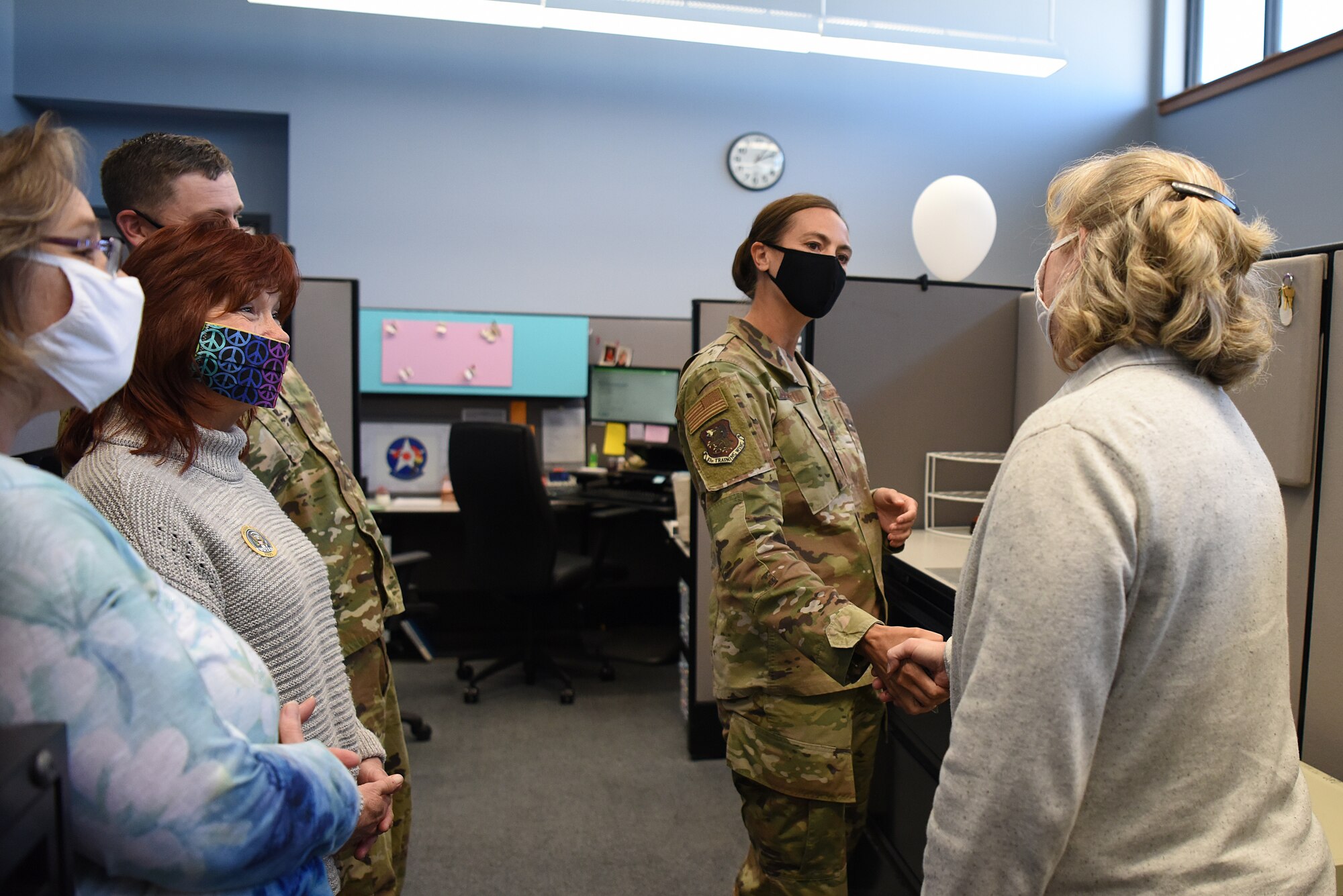 U.S. Air Force Col. Heather Blackwell, 81st Training Wing commander, coins Lisa David, 81st Contracting Squadron government purchase card program coordinator, inside the 81st CONS building at Keesler Air Force Base, Mississippi, Nov. 3, 2020. David was coined for her outstanding work during the end of year close-out. (U.S. Air Force photo by Senior Airman Suzie Plotnikov)