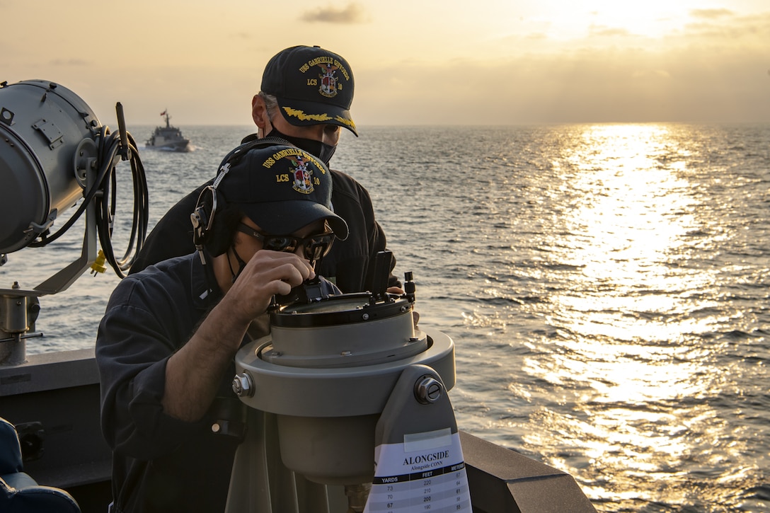 Lt. j.g. Timothy Wenholz, assigned to the Independence-class littoral combat ship USS Gabrielle Giffords (LCS 10), uses a bearing circle in preparation for a replenishment-at-sea (RAS) with the  Chilean Navy replenishment oiler CNS Almirante Montt (AO-52) Nov. 7, 2020.