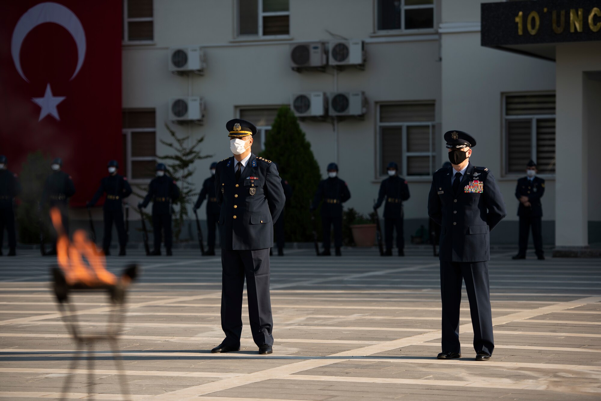 The 10th Tanker Base commander and the 39th Air Base Wing commander stand at parade rest during a ceremony.
