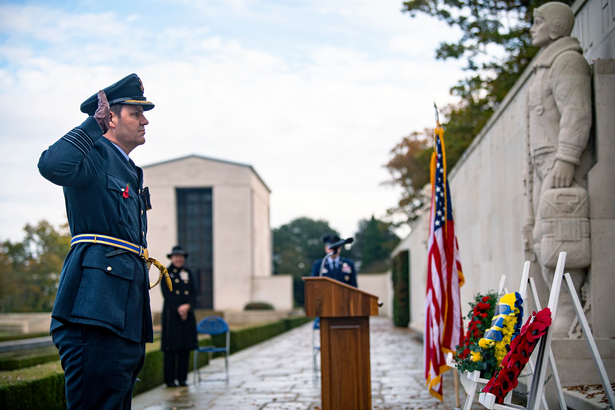 Royal Air Force Group Captain Phil Arnold, RAF High Wycombe commander, salutes after laying a wreath along the Tablets of the Missing during a Veterans Day ceremony at the Cambridge American Cemetery and Memorial, England, Nov. 9, 2020. The Tablets honor veterans of the past and present for their service to the United States. (U.S Air Force photo by Senior Airman Eugene Oliver)